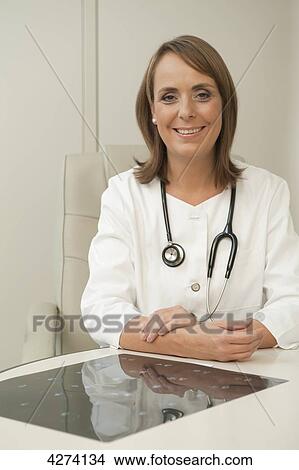 Smiling female doctor in medical practice View Large Photo Image Picture - Smiling female doctor in medical practice . Fotosearch