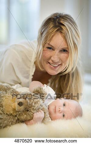 Stock Image - Smiling mother with baby . Fotosearch