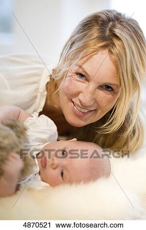 Stock Image - Smiling mother with baby . Fotosearch