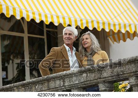 Smiling senior couple behind railing, Italy, Gardone Riviera View Large Photo Image Stock Photograph - Smiling senior couple behind railing, Italy, Gardone Riviera . Fotosearch