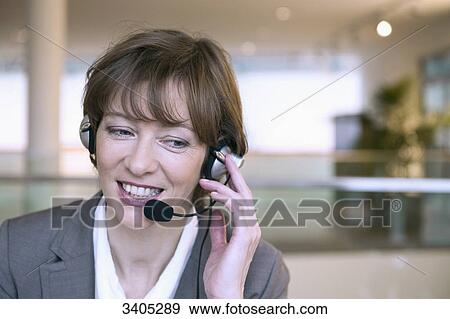 Smiling woman with headset View Large Photo Image Stock Photo - Smiling woman with headset . Fotosearch