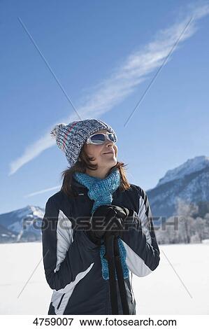 Smiling woman with nordic walking poles in winter landscape, Tannheimer Tal, Tyrol, Austria View Large Photo Image Stock Photo - Smiling woman with nordic walking poles in winter landscape, Tannheimer Tal, Tyrol, Austria . Fotosearch