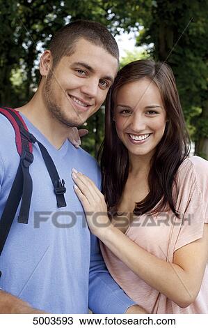 Stock Image - Smiling young couple outdoors . Fotosearch