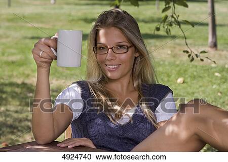 Smiling young woman with cup of coffee outdoors View Large Photo Image Stock Image - Smiling young woman with cup of coffee outdoors . Fotosearch