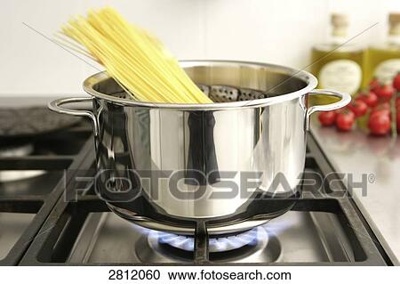 Stock Image - Spaghetti pasta cooking on stove . Fotosearch