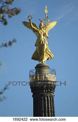 Stock Image - Statue of angel on column . Fotosearch