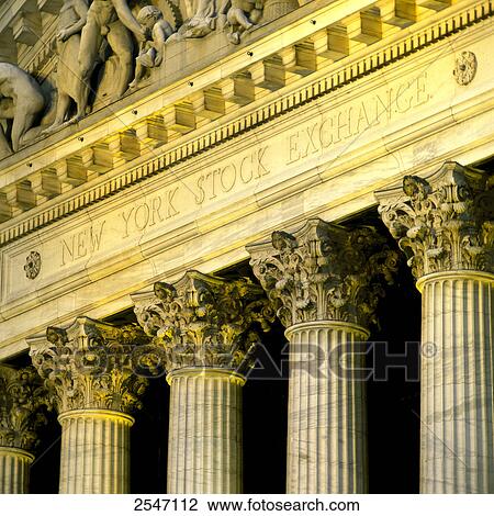 Stock Image - Stock exchange building lit up at dusk, New York Stock Exchange, New York City, New York State, USA . Fotosearch