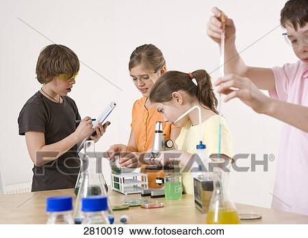 Students doing experiment in chemistry laboratory View Large Photo Image Stock Photo - Students doing experiment in chemistry laboratory . Fotosearch