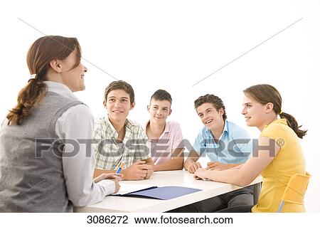 Stock Image - Students listening to a teacher . Fotosearch
