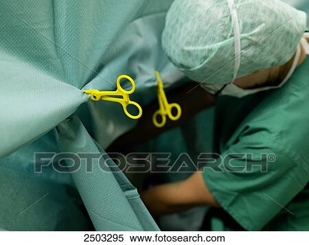 Stock Photography - Surgeon performing operation in operating room . Fotosearch