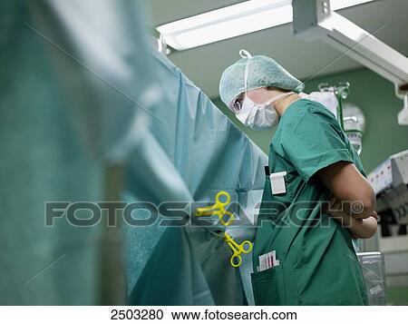 Surgeon standing in operating room View Large Photo Image Stock Image - Surgeon standing in operating room . Fotosearch