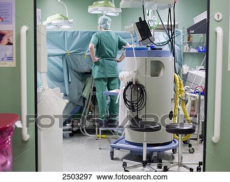 Surgeon standing in operating room View Large Photo Image Stock Photo - Surgeon standing in operating room . Fotosearch