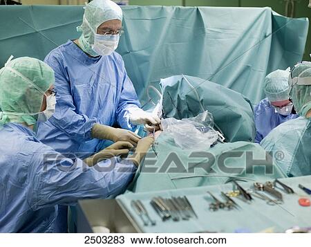Surgeons performing operation in operating room View Large Photo Image Stock Image - Surgeons performing operation in operating room . Fotosearch