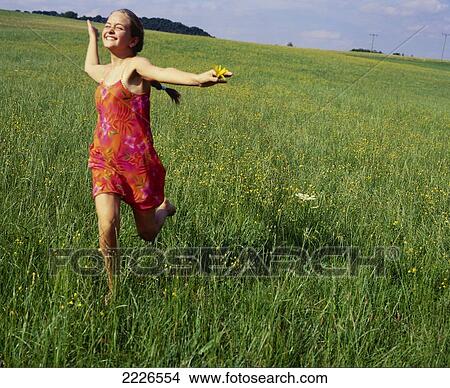 Teenage girl running in field View Large Photo Image Picture - Teenage girl running in field . Fotosearch