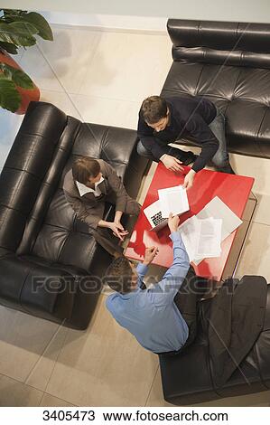 Stock Image - Three business people in a meeting . Fotosearch