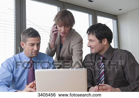Three business people in a meeting View Large Photo Image Stock Photograph - Three business people in a meeting . Fotosearch