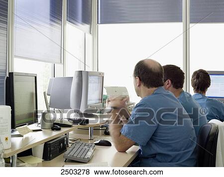 Stock Photo - Three surgeons looking at computers . Fotosearch