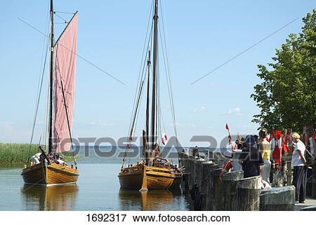 Tourists and sailboats at harbor View Large Photo Image Stock Photo - Tourists and sailboats at harbor . Fotosearch
