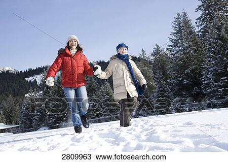 Tourists enjoying in snow covering landscape View Large Photo Image Stock Image - Tourists enjoying in snow covering landscape . Fotosearch
