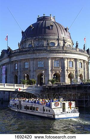 Stock Image - Tourists on boat in river . Fotosearch