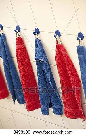 Towels hanging in a row on the wall View Large Photo Image Stock Image - Towels hanging in a row on the wall . Fotosearch