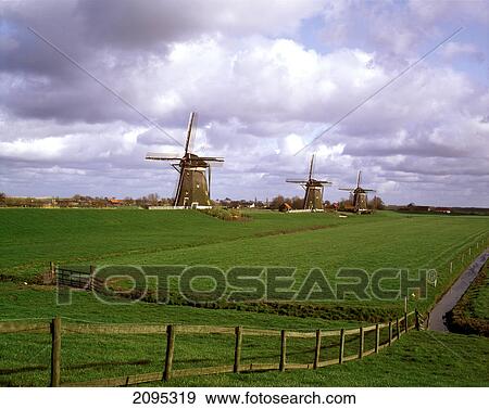 Traditional windmills in field View Large Photo Image Stock Photo - Traditional windmills in field . Fotosearch