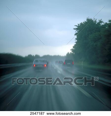 Traffic on highway in rain View Large Photo Image Stock Photo - Traffic on highway in rain . Fotosearch