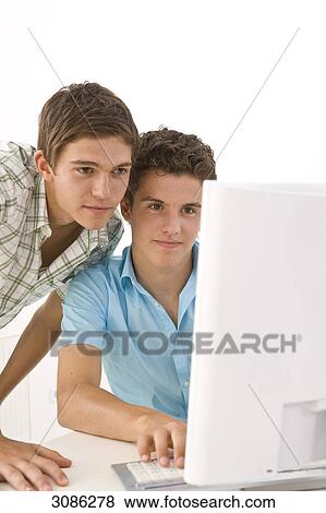 Two boys in front of a computer View Large Photo Image Stock Photo - Two boys in front of a computer . Fotosearch