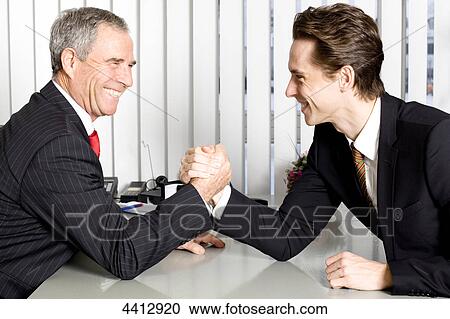 Two businessmen doing arm wrestling View Large Photo Image Stock Image - Two businessmen doing arm wrestling . Fotosearch