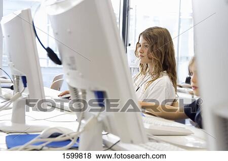 Two children working on laptop View Large Photo Image Stock Photo - Two children working on laptop . Fotosearch