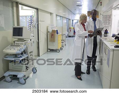 Picture - Two doctors standing in corridor of hospital . Fotosearch