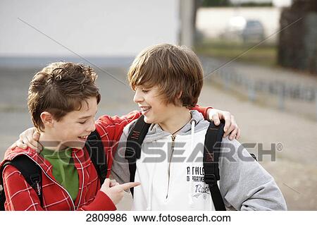 Two friends laughing together View Large Photo Image Stock Photograph - Two friends laughing together . Fotosearch