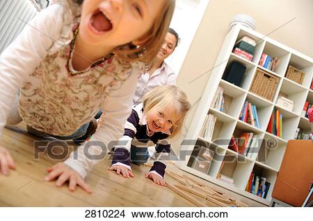 Two girls with their mother in room View Large Photo Image Picture - Two girls with their mother in room . Fotosearch