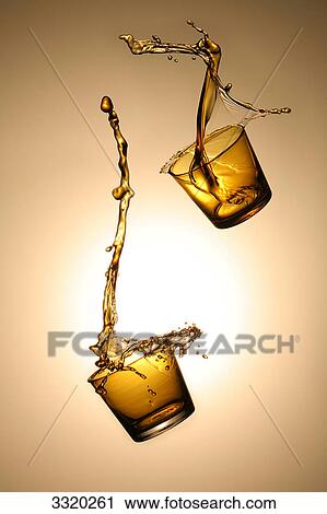Two whisky glasses in the air View Large Photo Image Stock Image - Two whisky glasses in the air . Fotosearch