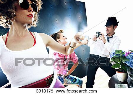 Two womem and one man on a party View Large Photo Image Stock Photography - Two womem and one man on a party . Fotosearch