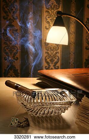 Unlit cigar in ashtray on a bedside table View Large Photo Image Stock Image - Unlit cigar in ashtray on a bedside table . Fotosearch