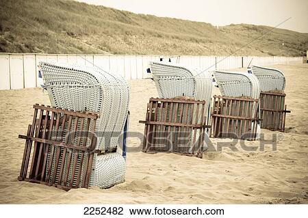 Stock Image - Wicker beach chairs on beach . Fotosearch