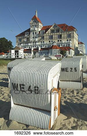 Stock Photograph - Wicker beach chairs on beach . Fotosearch