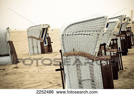 Stock Photograph - Wicker beach chairs on beach . Fotosearch