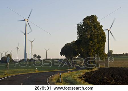 Wind turbines in field View Large Photo Image Stock Image - Wind turbines in field . Fotosearch