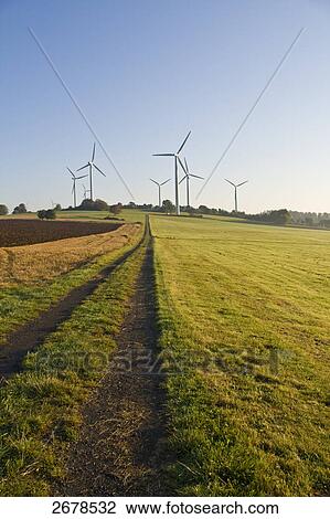 Stock Image - Wind turbines in field . Fotosearch