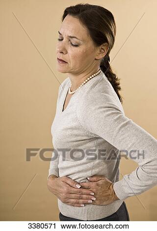 Woman having bellyache View Large Photo Image Stock Image - Woman having bellyache . Fotosearch