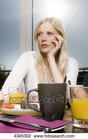 Stock Image - Woman having breakfast . Fotosearch