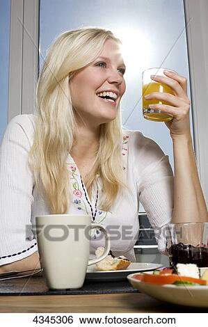 Woman having breakfast View Large Photo Image Stock Photograph - Woman having breakfast . Fotosearch