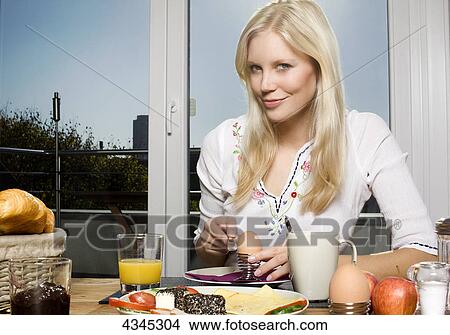 Woman having breakfast with egg View Large Photo Image Picture - Woman having breakfast with egg . Fotosearch