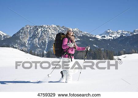 Stock Photo - Woman hiking in snow, Tannheimer Tal, Tyrol, Austria . Fotosearch