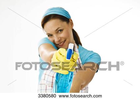 Woman holding spray bottle, front view View Large Photo Image Stock Image - Woman holding spray bottle, front view . Fotosearch