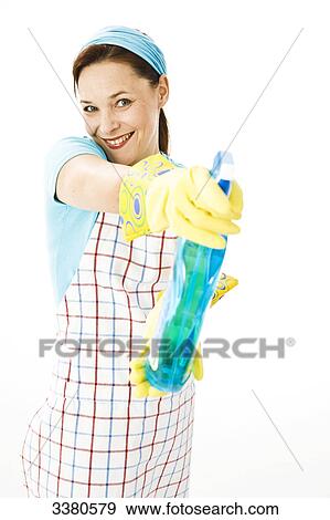 Woman holding spray bottle, front view View Large Photo Image Stock Photo - Woman holding spray bottle, front view . Fotosearch