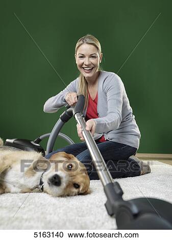 Stock Image - Woman hoovering . Fotosearch