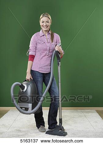 Woman hoovering View Large Photo Image Stock Photo - Woman hoovering . Fotosearch